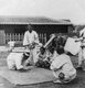 Korea: A group of Korean men gambling in the street, Seoul, early 20th century